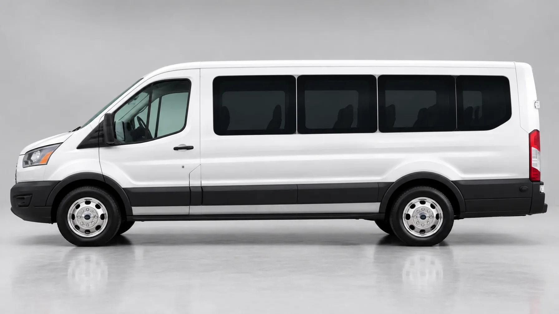 White 2023 Ford Transit van in side profile on a light gray studio backdrop